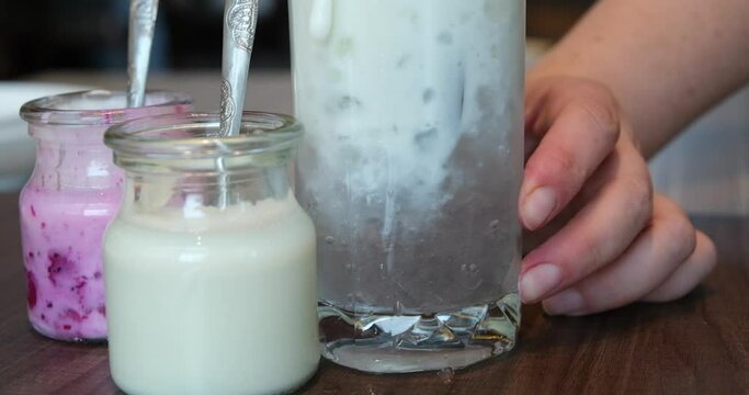 Barista stirring a milkshake. motion photo seamless loop. Milkshake