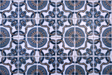 Intricate blue floral motifs on white tiles, reflecting art and culture