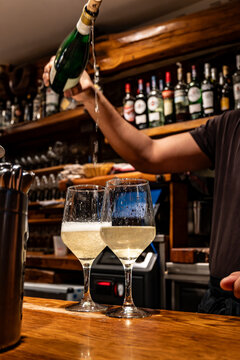 Pouring of txakoli or chacol&iacute; slightly sparkling very dry white wine produced in Spanish Basque Country in typical pinchos bar in old part of San Sebastian or Donostia, Spain