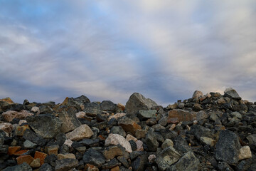 Obraz premium Mining industry waste rock dump with sky. Background concept. Copy space. Template for presentation.