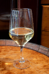 Glass of txakoli or chacolí slightly sparkling very dry white wine produced in Spanish Basque Country in typical pinchos bar in old part of San Sebastian or Donostia, Spain