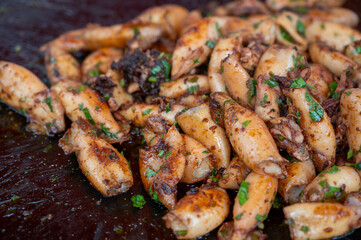 Assortment of fresh daily catch of prawns, seashells, molluscs on ice on fish market in Brittany, France, English translation: differens French names of seafood