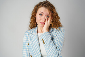 Young Woman Covering Face With Hands in Studio