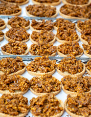 Walnuts tart cake form Perigord, Dordogne, fresh baked nuts cake on local farmers market in Saplat-du-Caneda, Perigord, France