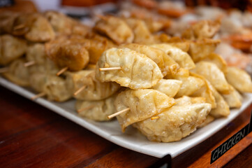 Typical snack of Basque Country, pinchos or pinxtos skewers with small pieces of bread, sea food, eggs, cheese, jamon served in bar in San-Sebastian or Bilbao, Spain, close up