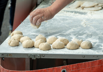 Making of flat pita bread on street market
