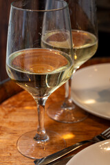 Glass of txakoli or chacolí slightly sparkling very dry white wine produced in Spanish Basque Country in typical pinchos bar in old part of San Sebastian or Donostia, Spain