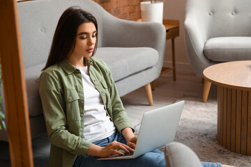 Female freelancer working with laptop at home