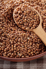 Raw Buckwheat Grains in Clay Bowl, Close Up