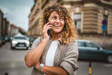 Adult beautiful woman talk on mobile phone stand on the street