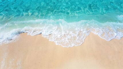 Crystal clear turquoise waves gently lap at soft, pristine sandy beach
