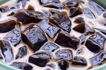 Grass jelly in milk with brown sugar, herbal dessert. Mesona chinensis