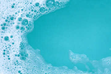 Detergent foam bubble on water. Blue background, Soap sud