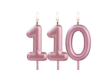 Candle number 110 - Lit birthday candle on white background