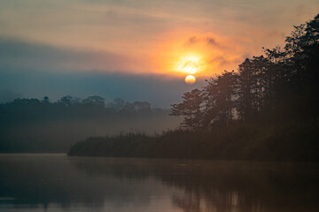 Sunrise above a remote wilderness rainforest and river in the jungles of Borneo