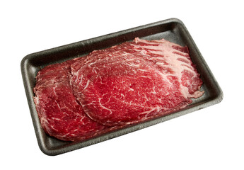 Thinly sliced ​​fresh beef arranged on a black tray isolated on white background.