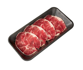 Thinly sliced ​​fresh Beef with a high layer of fat arranged on a black tray isolated on white background.