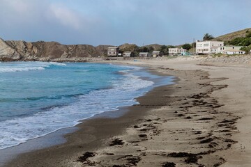 Beachside houses and sandy beach in Pacifica, San Francisco, California, USA.
