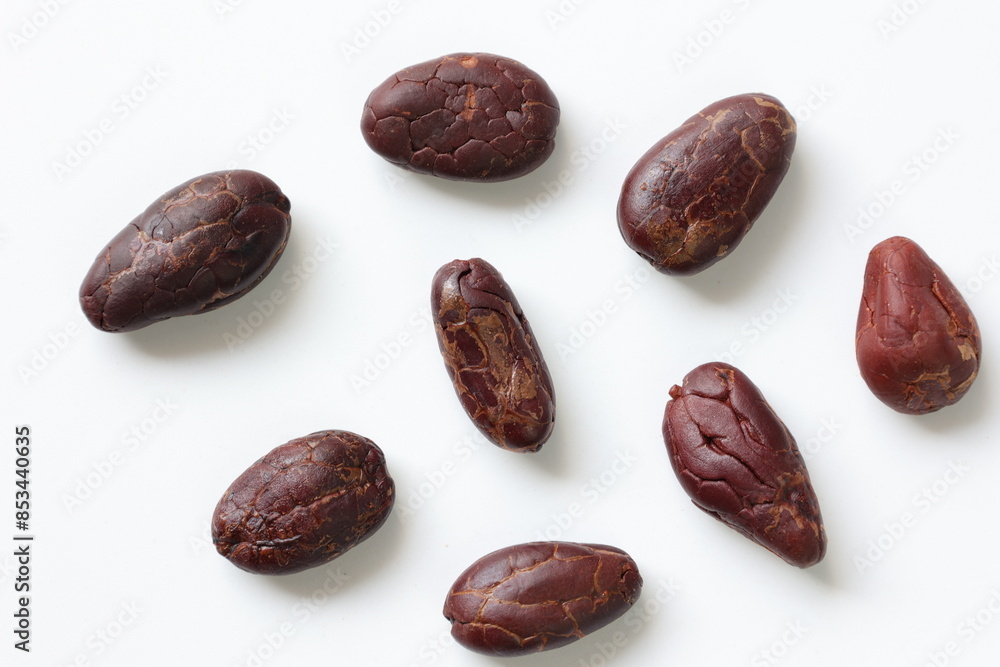 Wall mural Cocoa beans on white background 