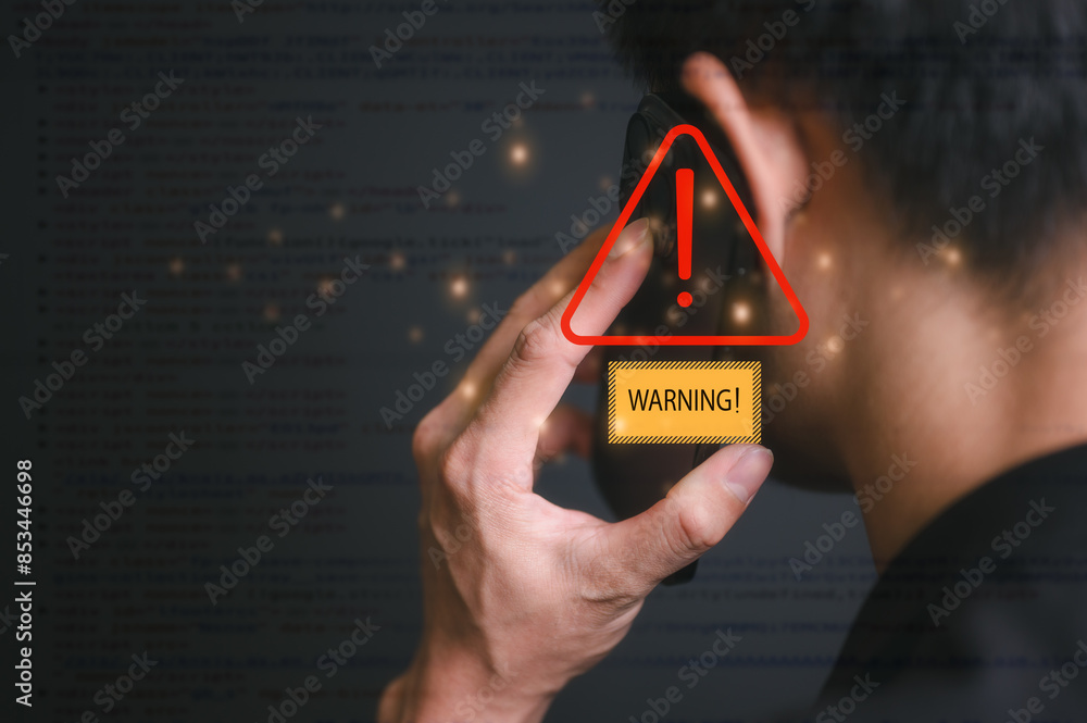 Poster risk and cyber security technology concept man holding mobile phone with alert warning triangle sign