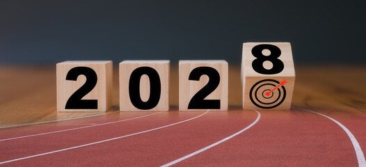 Multi exposure of running track and wooden cube 2028 target board new year in concept of action...