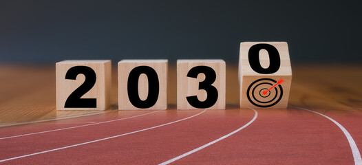 Multi exposure of running track and wooden cube 2030 target board new year in concept of action...