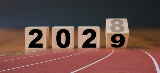 Multi exposure of running track and wooden cube 2029 2028 new year in concept of action business...