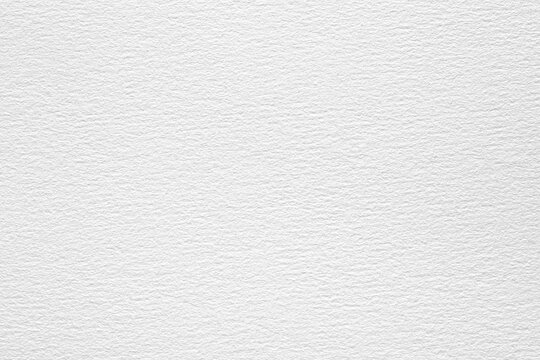 A close-up shot of a white watercolor paper texture with a subtle embossed pattern.
