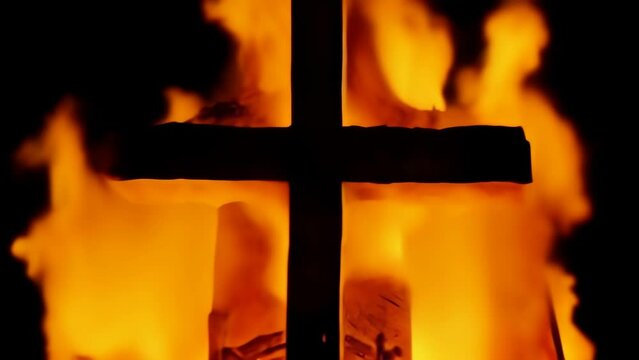 Zooming Cross in Flames - a dark cross engulfed in intense flames against a black background. The flames, vivid and fierce, surround the cross, creating a dramatic and powerful visual.