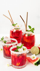 Watermelon drink in glasses with slices of watermelon.