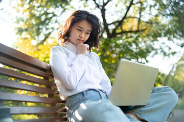 a woman taking a break in the park in the fall