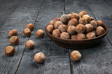 Rustic Bowl of Hazelnuts on Dark Wooden Table Nutritious Snack in Natural Setting