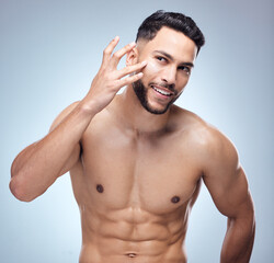 Fototapeta premium Skincare, portrait and happy man in studio with cream for cosmetics, natural glow or treatment on white background. Body, hands and model with lotion for satisfaction, dermatology or moisturizer