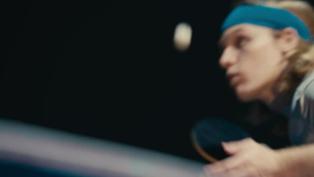 Close up of a ping pong player ready to serve