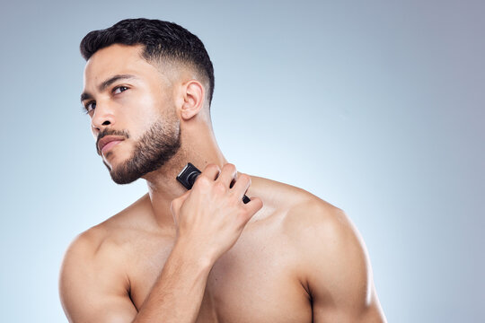 Man, shaver and beard beauty in studio, facial and hair removal or grooming wellness with trimmer on background. Cosmetic, cleaning razor and morning routine, hygiene product and dermatology skincare