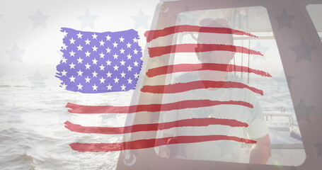 Fototapeta premium American flag design pattern against caucasian man sitting in a boat