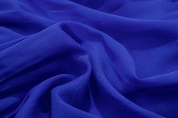 Close-up of blue fabric with soft folds and texture