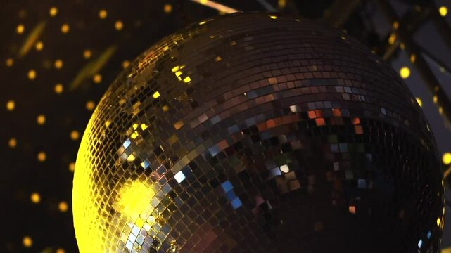 A glittering disco ball reflects vibrant lights, creating a festive atmosphere