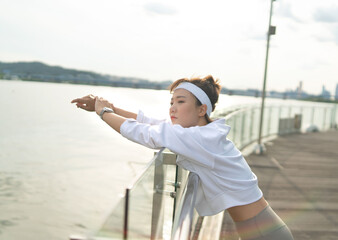 a woman who works out at a riverside park