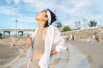 Fototapeta premium a woman who works out at a riverside park
