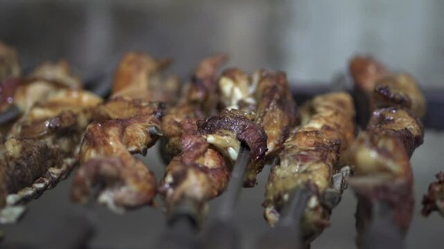 Meat on a skewer on the restaurant grill. Traditional Argentine barbecue. Closeup Slow motion. Miguel Lan&uacute;s, Posadas, Misiones.