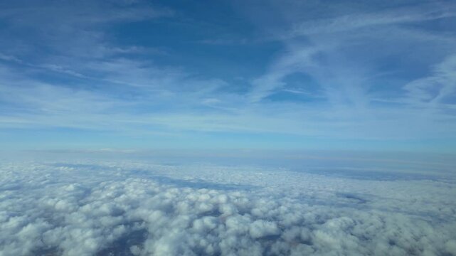 Sky view POV flying over some clouds. Shot from a jet flying at supersonic speed. Daylight. 4K