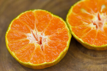 close up view of orange slice  on wood table . fresh orange fruit . Orange half clipping path