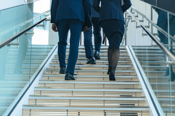 A group of multinational business people walking up the stairs