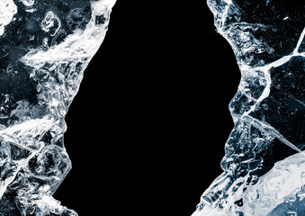 Hole, broken in a pure transparent crushed ice with cracks on a black background, close-up.