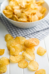 Crispy Potato Chips on white table.
