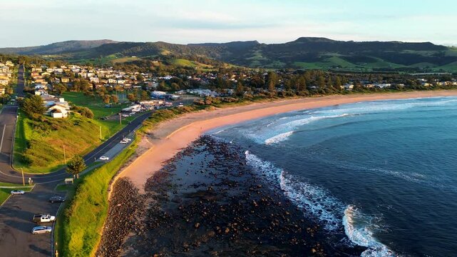 Landscape drone aerial of Gerringong main town sandy beach ocean waves residential street neighbourhood carpark South Coast tourism travel Australia