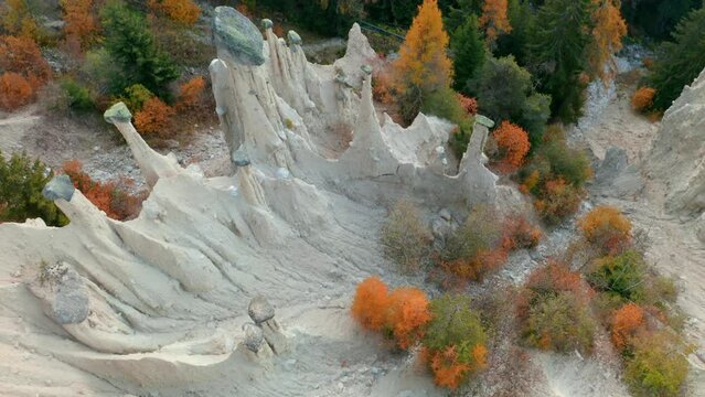 4K aerial - a bird's eye view&nbsp;video (Ultra High Definition) of Earth pyramids of Platten - Spiky sand towers formed by water erosion and accessed by a woodland trail dotted with sculpture.