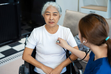 Doctor with stethoscope examining elderly patient with examination, presenting symptoms and...
