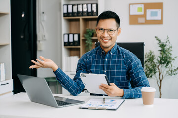 Fototapeta premium Businessman executive manager looking at laptop watching online webinar training or having virtual meeting video conference doing market research working
